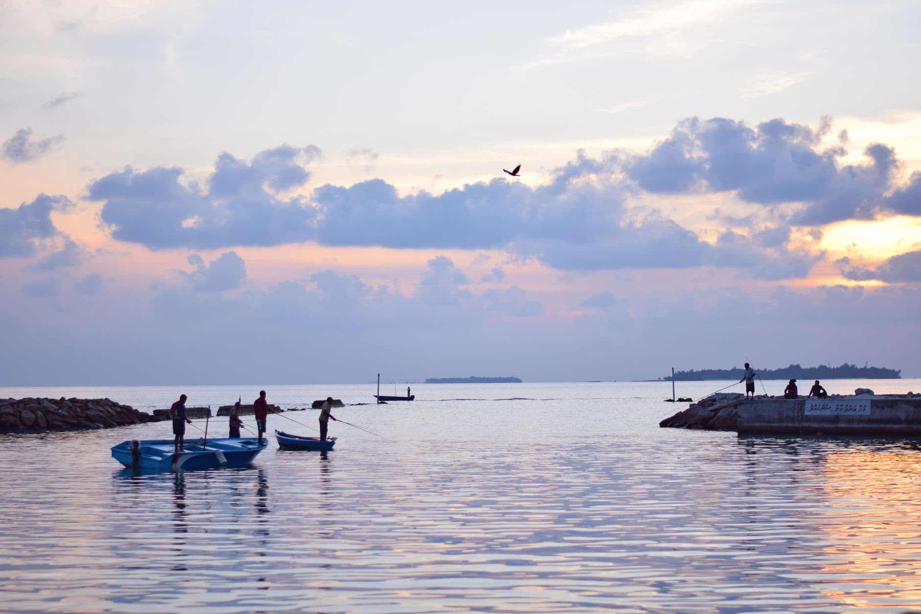 Handline fishing from a Maldivian boat as the sun sets over the ocean