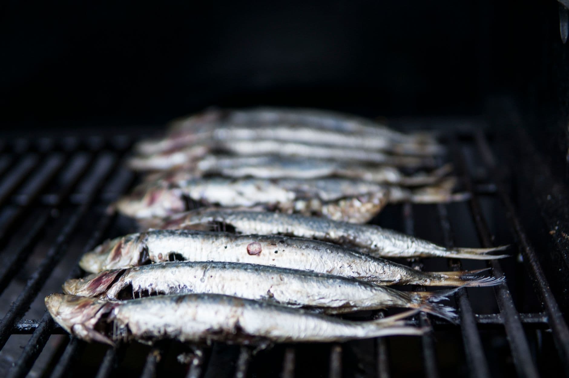 Freshly caught reef fish grilling on a boat barbecue