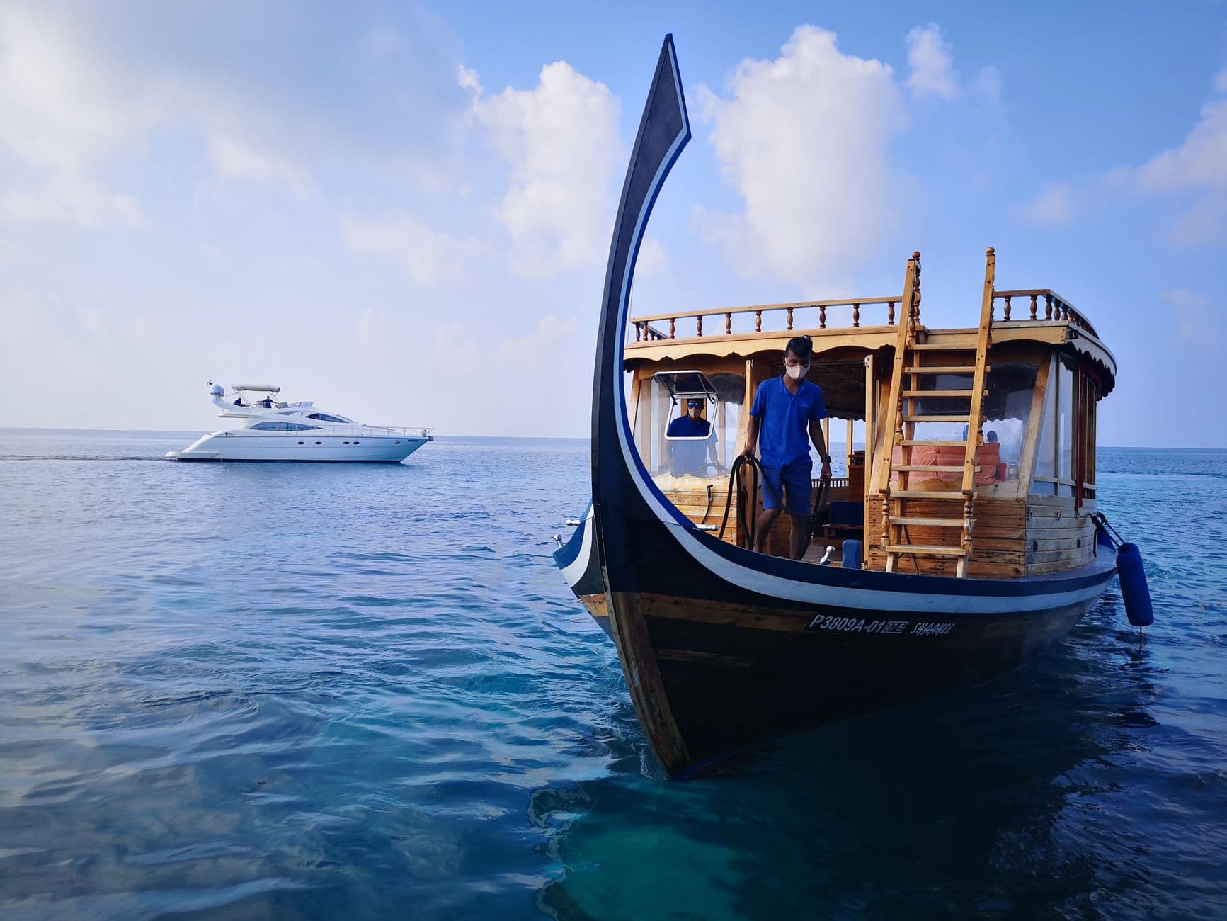 A dhoni on clear water off Malé